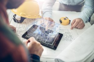 mimarlık-2 Architect and his client looking at the hologram of a house project over a tablet computer. The client is reviewing his future house layout
Note to inspector: I am the author of the building project